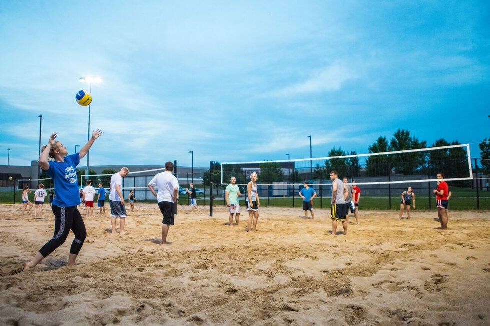 im volleyball game with a player serving the ball